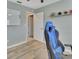 Bedroom with wood-look flooring and a blue gaming chair at 2585 Delbarton Ave, Deltona, FL 32725