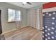 Bedroom with light wood flooring, ceiling fan, and window coverings at 2585 Delbarton Ave, Deltona, FL 32725