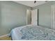 Bedroom with light gray walls, wood-look flooring, and a bed at 2585 Delbarton Ave, Deltona, FL 32725