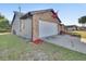 Attached garage with brick and metal siding at 2585 Delbarton Ave, Deltona, FL 32725