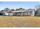 Brick house with metal roof, landscaping, and driveway at 2585 Delbarton Ave, Deltona, FL 32725