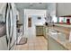 Granite countertops, stainless steel appliances, and light green cabinets at 2585 Delbarton Ave, Deltona, FL 32725