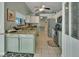 Open kitchen featuring granite countertops and light green cabinets at 2585 Delbarton Ave, Deltona, FL 32725