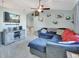 L-shaped sectional sofa, large TV, ceiling fan, and neutral wall colors at 2585 Delbarton Ave, Deltona, FL 32725