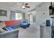 L-shaped sectional sofa, view of entryway, ceiling fan, and neutral wall colors at 2585 Delbarton Ave, Deltona, FL 32725