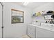 Laundry room with washer, dryer, and overhead shelving at 274 Sunrise Blvd, Debary, FL 32713