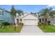 Front view of a single-story house with a two-car garage and landscaping at 2924 Taton Trce, New Smyrna Beach, FL 32168