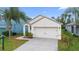 Front view of a single-story house with a two-car garage at 2924 Taton Trce, New Smyrna Beach, FL 32168