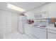 White kitchen with full-size appliances and ample cabinet storage at 2967 S Atlantic Ave # 204, Daytona Beach Shores, FL 32118