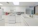 White kitchen with appliances, ample counter space, and a breakfast bar at 2967 S Atlantic Ave # 204, Daytona Beach Shores, FL 32118