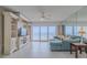 Bright living room with ocean view, featuring a sectional sofa and built-in entertainment center at 2967 S Atlantic Ave # 204, Daytona Beach Shores, FL 32118