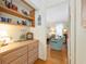 Bright hallway with built-in shelves and dresser leading to bedroom at 3019 John Anderson Dr, Ormond Beach, FL 32176