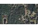 Aerial view shows expansive property with multiple buildings and a large lake nearby at 353 Vannote Rd, Pierson, FL 32180