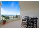 Enjoy breathtaking ocean views from this balcony with a dining table and chairs at 395 S Atlantic Ave # 104, Ormond Beach, FL 32176