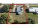 Aerial view of a house with a large backyard and solar panels at 610 Nardello Dr, Deltona, FL 32725