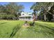 Two story house with screened porch and fire pit in the front yard at 624 E Old Mill Dr, Debary, FL 32713