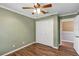 Light green bedroom with ceiling fan and double doors at 636 Preakness Cir, Deland, FL 32724