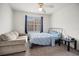 Second bedroom with a full-size bed and a sofa at 7280 Westpointe Blvd # 820, Orlando, FL 32835