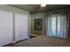 Bedroom with barn doors, a bed, and access to a patio at 741 Horseman Dr, Port Orange, FL 32127