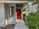 Inviting front entrance with red door and walkway at 101 N Hill S Ave # 7, Deland, FL 32724