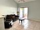 Living room with brown couch and access to patio at 101 N Hill S Ave # 7, Deland, FL 32724