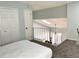 Spacious main bedroom with loft access and carpet flooring at 101 N Hill S Ave # 7, Deland, FL 32724