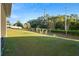 Private backyard with grass, trees, and a white fence at 1029 River Otter Way, Deland, FL 32720