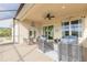 Covered patio with seating area and lake view at 112 Portofino Blvd, New Smyrna Beach, FL 32168