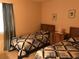 Bedroom with two twin beds and wood dresser at 150 Wax Myrtle Woods Ct # 9D, Deltona, FL 32725