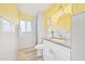 Bright bathroom with yellow walls and white tile at 1601 Ocean Shore Blvd # 1040, Ormond Beach, FL 32176