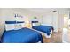 Guest bedroom with twin beds and nautical decor at 1601 Ocean Shore Blvd # 1040, Ormond Beach, FL 32176