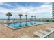 Inviting pool area with ocean views and lounge chairs at 1601 Ocean Shore Blvd # 1040, Ormond Beach, FL 32176