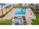 Community pool with lounge chairs and ocean view at 1601 Ocean Shore Blvd # 1040, Ormond Beach, FL 32176