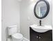 Basement bathroom with modern vanity, toilet and a black framed mirror at 1604 Carmen Ave, Daytona Beach, FL 32117