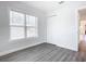 Well-lit bedroom with grey flooring and a closet at 1604 Carmen Ave, Daytona Beach, FL 32117