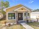 House exterior features a welcoming porch and landscaping at 1604 Carmen Ave, Daytona Beach, FL 32117