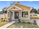 House exterior features a welcoming porch and landscaping at 1604 Carmen Ave, Daytona Beach, FL 32117