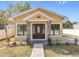 House exterior features a welcoming porch and landscaping at 1604 Carmen Ave, Daytona Beach, FL 32117