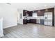 Modern kitchen features dark wood cabinets, stainless steel appliances, and marble countertops at 1604 Carmen Ave, Daytona Beach, FL 32117