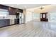 Open concept kitchen and living area with dark cabinetry and grey flooring at 1604 Carmen Ave, Daytona Beach, FL 32117