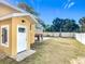Side yard with grass and white fence at 1604 Carmen Ave, Daytona Beach, FL 32117