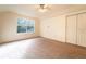 Spacious bedroom with carpet, large window and double doors to closet at 1907 Enterprise Osteen Rd, Deltona, FL 32738