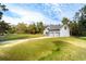 Two-story house with gray siding, two-car garage, and driveway at 1907 Enterprise Osteen Rd, Deltona, FL 32738