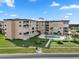 Condo building exterior with pool and landscaping at 2294 Ocean Shore Blvd # 401, Ormond Beach, FL 32176
