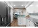 Kitchen with granite countertops, stainless steel appliances, and view to living room at 2294 Ocean Shore Blvd # 401, Ormond Beach, FL 32176