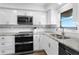 Updated kitchen featuring stainless steel appliances and granite countertops at 2294 Ocean Shore Blvd # 401, Ormond Beach, FL 32176