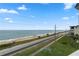 Ocean view from condo balcony, showing beach and road at 2294 Ocean Shore Blvd # 401, Ormond Beach, FL 32176