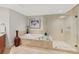 Spa-like bathroom featuring a soaking tub and a glass-enclosed shower at 231 Riverside Dr # 701, Holly Hill, FL 32117