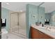 Modern bathroom with glass shower and light teal walls at 231 Riverside Dr # 701, Holly Hill, FL 32117