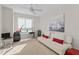 Bedroom with white sofa, desk, and sailboat artwork at 231 Riverside Dr # 701, Holly Hill, FL 32117